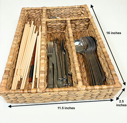 A handwoven water hyacinth cutlery and drawer organizer filled with various utensils, measuring 16 inches in length, 11.5 inches in width, and 2.